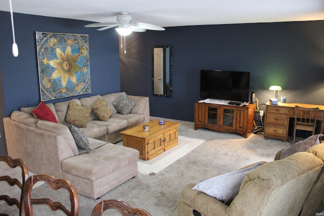 carpeted living room with a ceiling fan