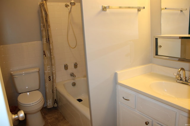 full bathroom featuring shower / tub combo with curtain, tile walls, toilet, vanity, and tile patterned floors