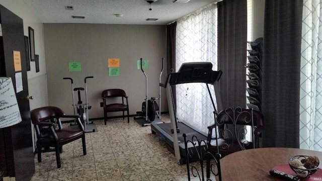 workout area featuring a textured ceiling