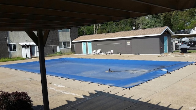 pool featuring an outbuilding and fence