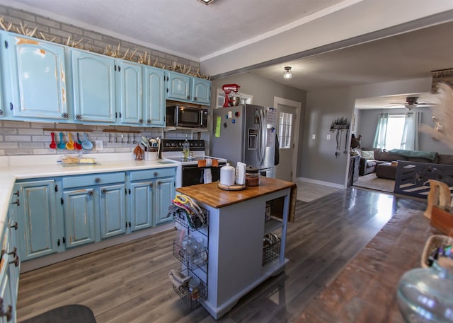 kitchen featuring blue cabinets, butcher block counters, range with electric stovetop, wood finished floors, and stainless steel fridge with ice dispenser