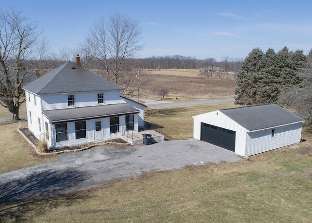 view of front of home featuring a detached garage, a chimney, roof with shingles, an outdoor structure, and a porch