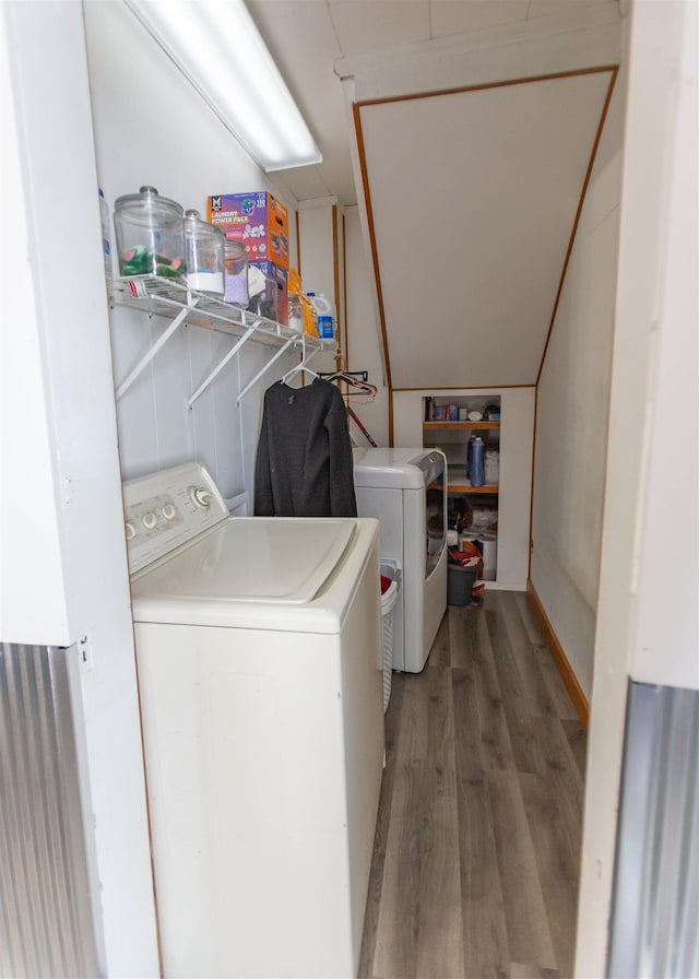 washroom featuring laundry area, separate washer and dryer, and wood finished floors