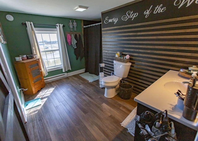 full bathroom with toilet, a shower with shower curtain, wood finished floors, baseboards, and baseboard heating