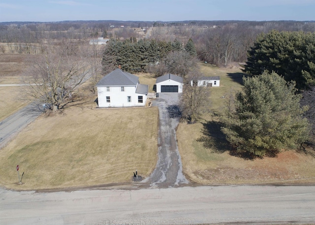 drone / aerial view featuring a wooded view