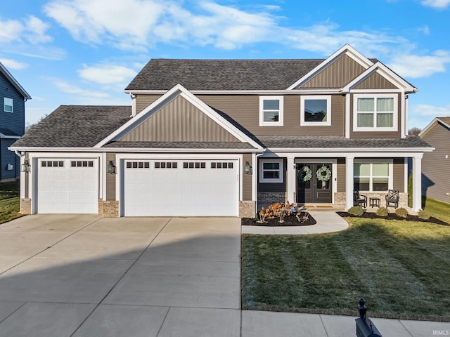 craftsman house with a garage, concrete driveway, a front lawn, and board and batten siding