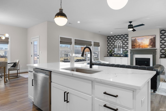 kitchen with plenty of natural light, open floor plan, a sink, and dishwasher