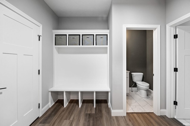 mudroom with wood finished floors and baseboards