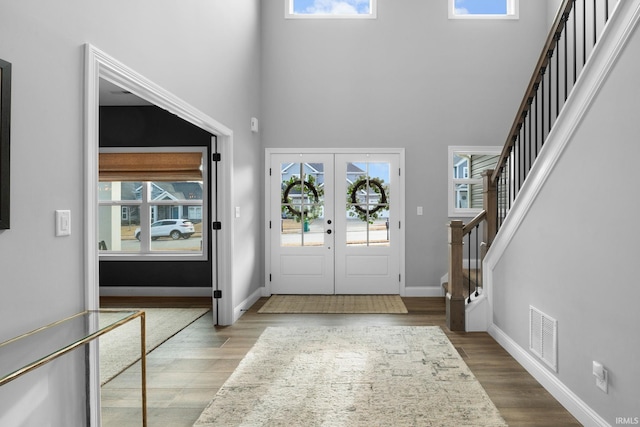 entryway featuring stairway, a wealth of natural light, and wood finished floors