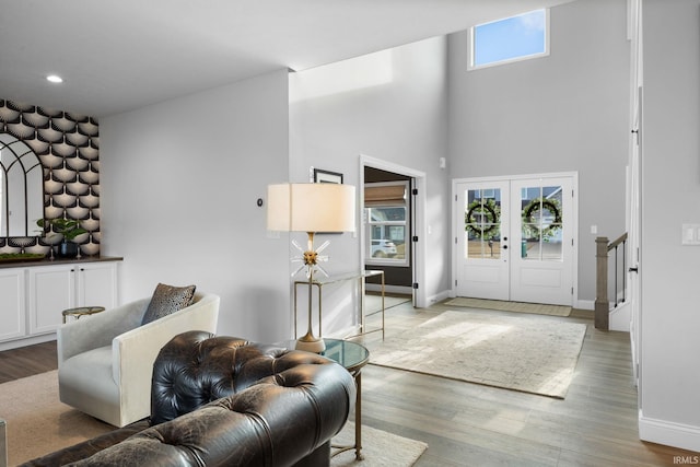 entryway featuring french doors, recessed lighting, light wood-type flooring, baseboards, and stairs