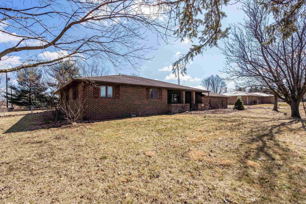 exterior space with a lawn and brick siding