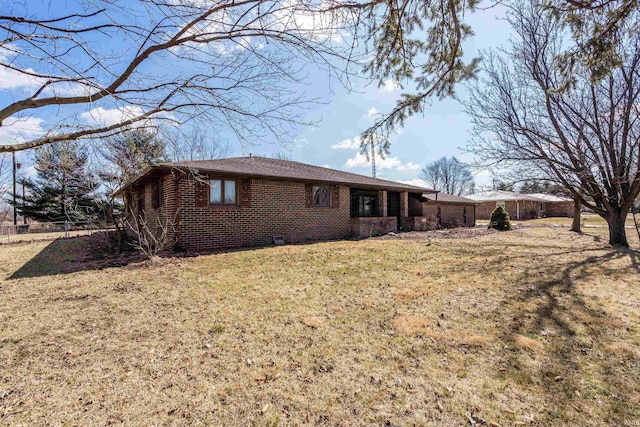 exterior space with a lawn and brick siding