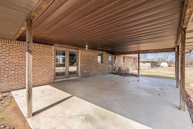 view of patio with central AC unit and an attached carport