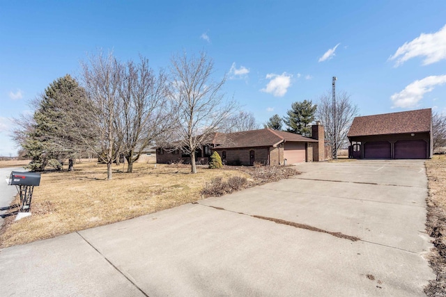 view of front of house with a garage and a chimney