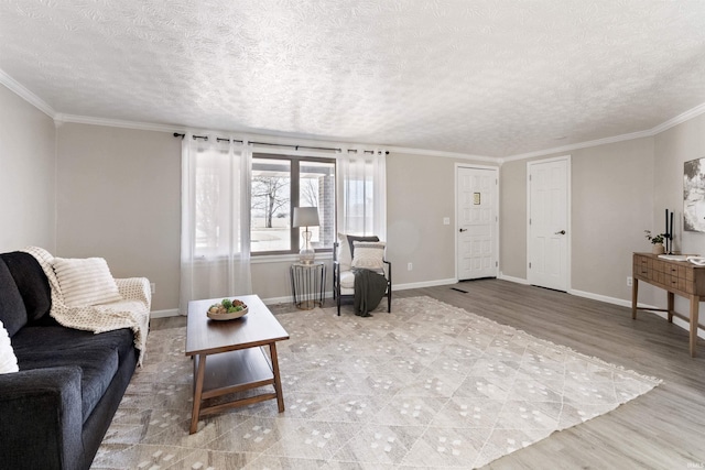 living room with light wood-style floors, crown molding, a textured ceiling, and baseboards