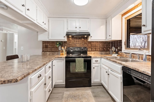 kitchen with under cabinet range hood, a sink, white cabinetry, backsplash, and black appliances