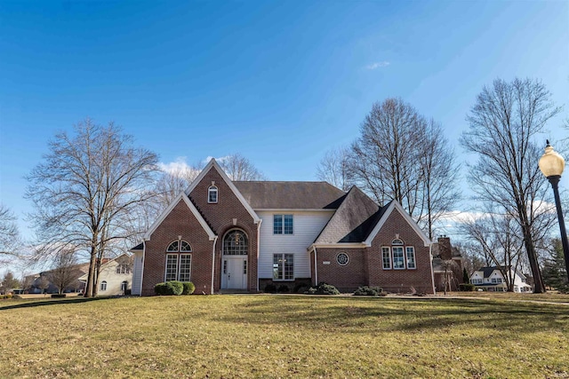 view of front of property with brick siding and a front lawn