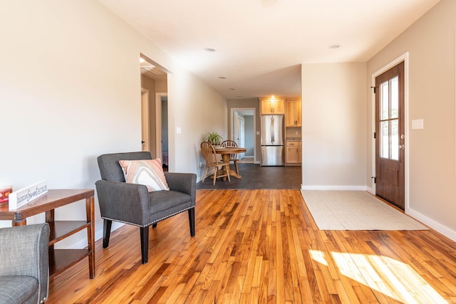 foyer featuring baseboards and light wood-style floors