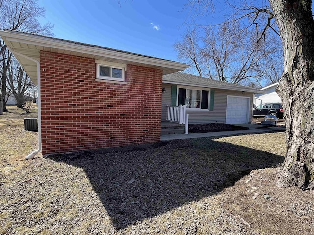 view of home's exterior featuring brick siding and an attached garage