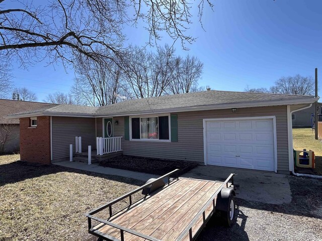 ranch-style house with a garage and driveway