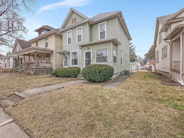 view of front of home with covered porch, central AC, and a front yard