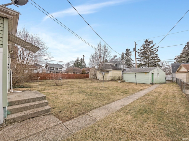 view of yard with an outbuilding and fence