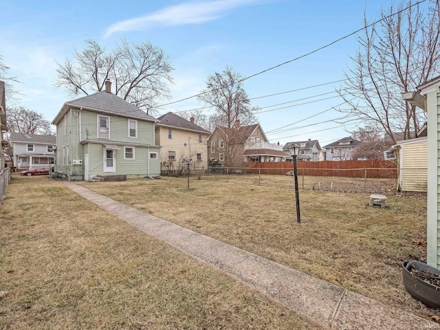 view of yard with a residential view and fence