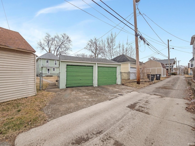 detached garage with fence and a gate