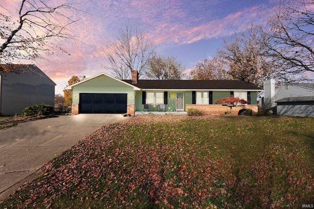 ranch-style house featuring a lawn, driveway, a chimney, and an attached garage