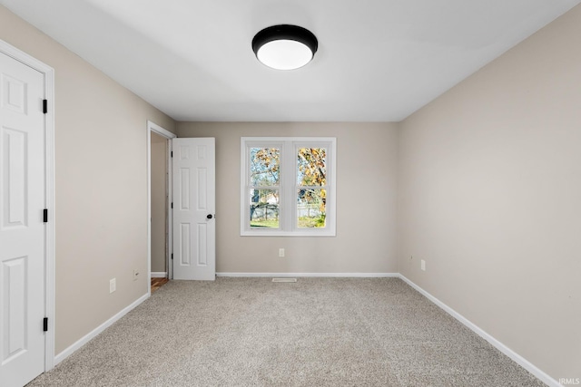 unfurnished bedroom featuring baseboards and carpet flooring