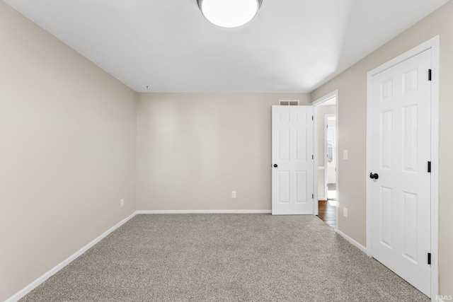 interior space with visible vents, baseboards, and carpet floors