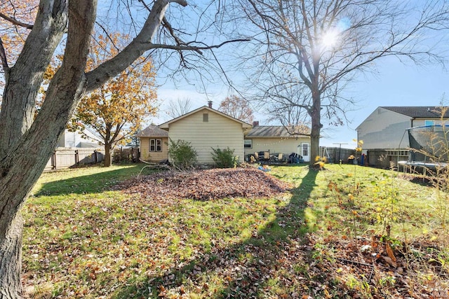 view of yard featuring a trampoline and a fenced backyard