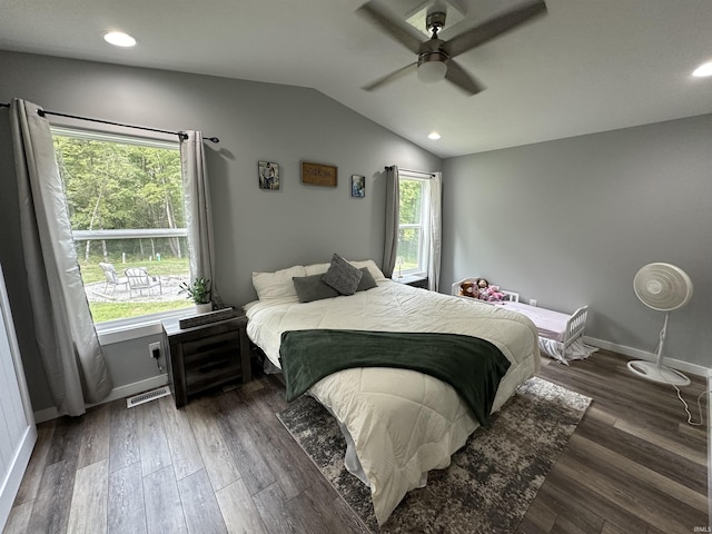 bedroom featuring visible vents, baseboards, lofted ceiling, wood finished floors, and a ceiling fan