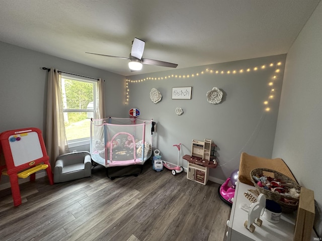 bedroom with wood finished floors, baseboards, and ceiling fan