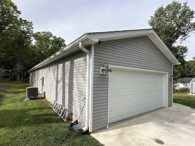 view of home's exterior with a garage, central air condition unit, an outbuilding, and a yard