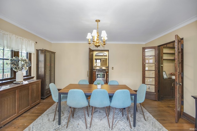 dining area featuring a chandelier, baseboards, wood finished floors, and ornamental molding