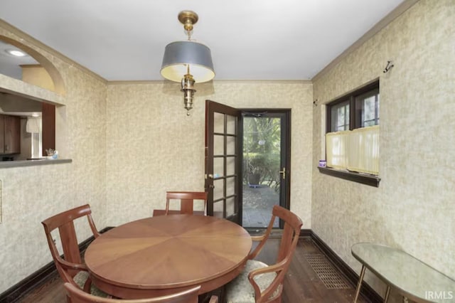 dining area with wallpapered walls, wood finished floors, and baseboards