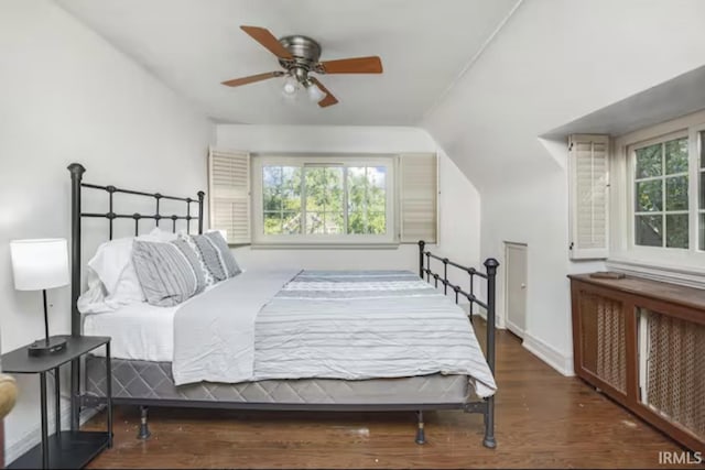 bedroom featuring radiator, ceiling fan, baseboards, lofted ceiling, and wood finished floors