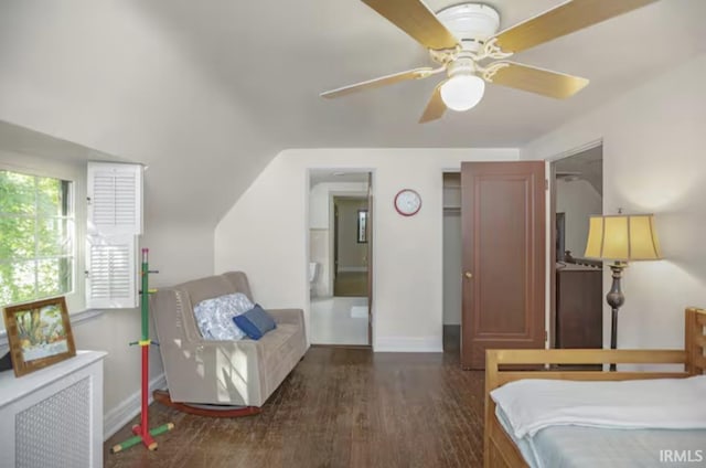 bedroom featuring dark wood finished floors, radiator, and baseboards