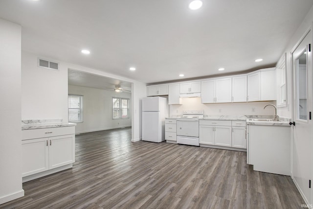 kitchen featuring visible vents, under cabinet range hood, dark wood finished floors, white cabinetry, and white appliances