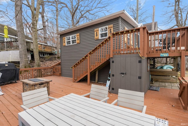 wooden deck featuring grilling area and stairs