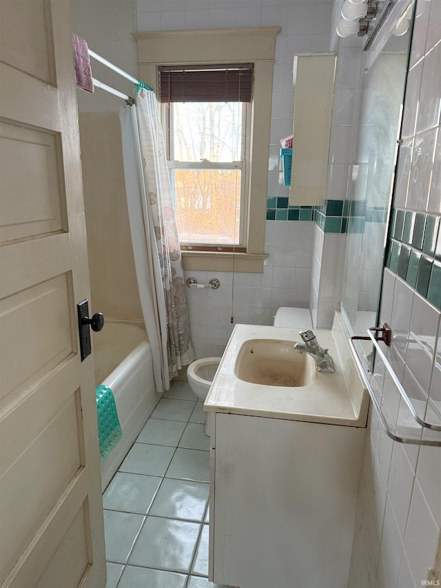 full bathroom with toilet, tile patterned flooring, tile walls, shower / bath combination with curtain, and vanity