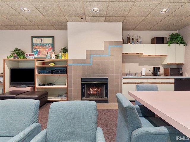 living room with a tiled fireplace and recessed lighting