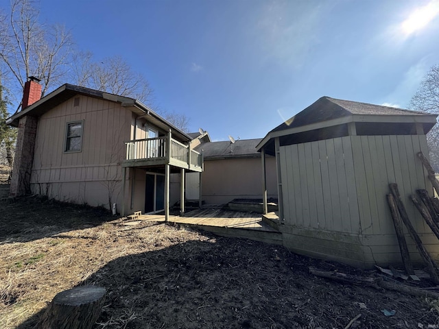 exterior space with a deck and a chimney