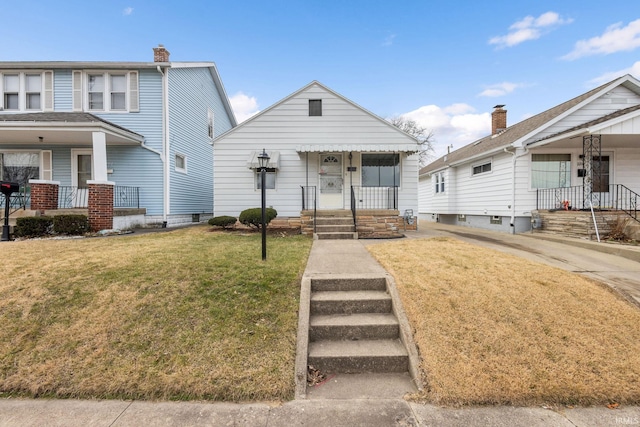 view of front of home with covered porch and a front lawn