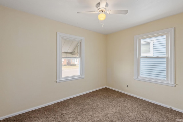 spare room featuring baseboards, carpet floors, and a ceiling fan