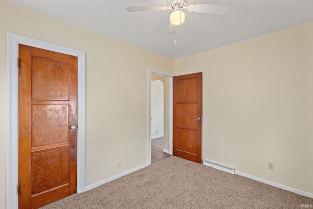 empty room with baseboards, carpet flooring, baseboard heating, and a ceiling fan