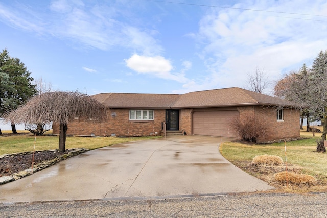 ranch-style home with brick siding, driveway, a front lawn, and a garage