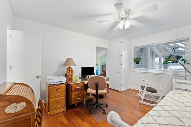 home office with ceiling fan and wood finished floors