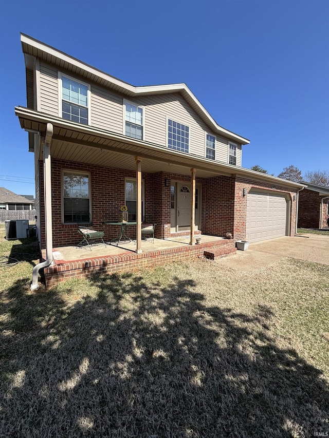 view of front of home featuring brick siding, an attached garage, and concrete driveway